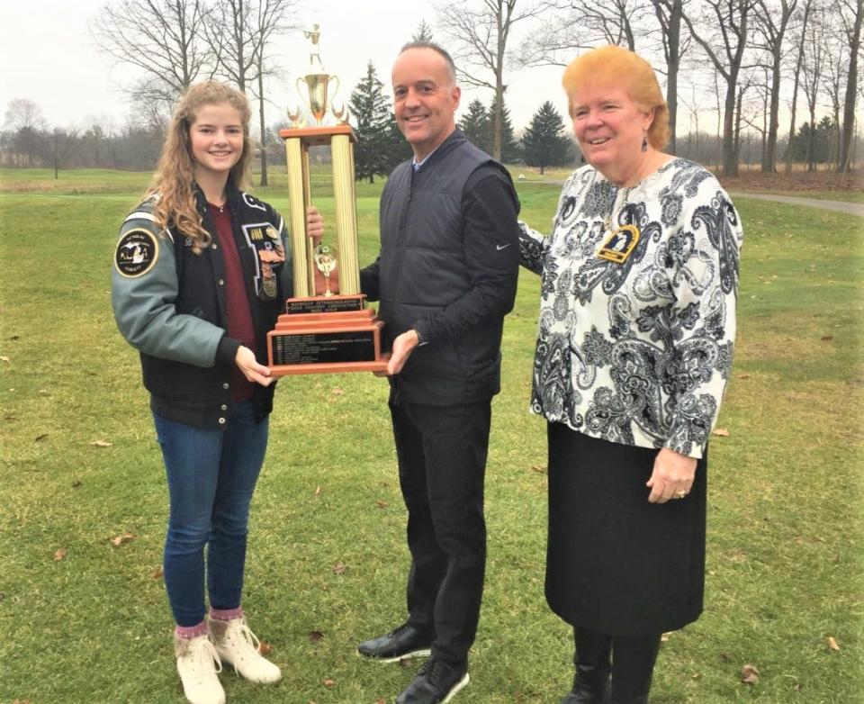 Bridget Boczar is pictured with Plymouth Golf Coach Dan Young and Michigan Interscholastic Golf Coaches Association President Debbie Williams-Hoak during the Dec. 10 Miss Golf trophy presentation at Fox Hills Golf Course in Plymouth.