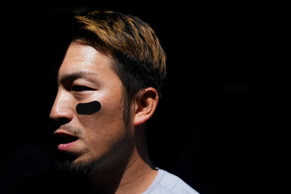 Chicago Cubs designated hitter Seiya Suzuki walks in the dugout before a baseball game against the Seattle Mariners, Sunday, April 14, 2024, in Seattle. (AP Photo/Lindsey Wasson)