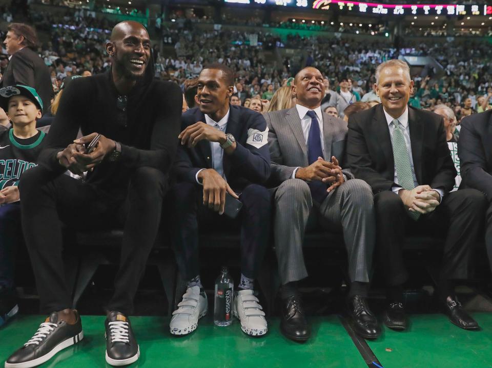 Former Boston Celtics (left to right) Kevin Garnett, Rajon Rondo, coach Doc Rivers and current general manager Danny Ainge look on during the second quarter of the game between the Boston Celtics and the Cleveland Cavaliers at TD Garden.