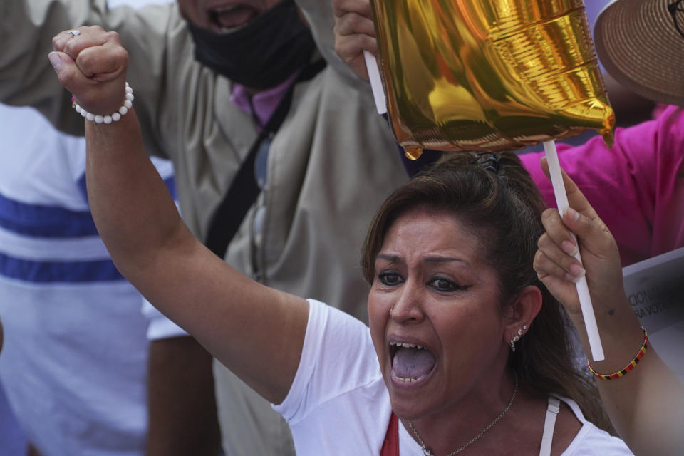 A woman shouts slogans as citizen organizations march in support of Mexico's National Elections Institute as President Andrés Manuel López Obrador pushes to reform it, in Mexico City, Sunday, Nov. 13, 2022. (AP Photo/Marco Ugarte)