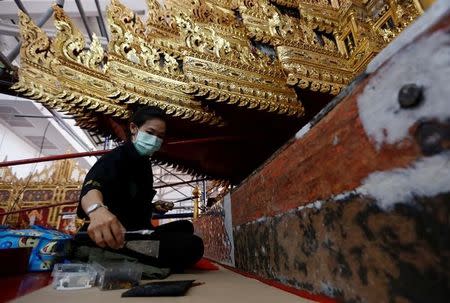 Thai officials from the Conservation Science Division of the Fine Arts Department of the National Museum of Thailand repairs the Royal Chariot, which will be used during the late King Bhumibol Adulyadej's funeral later this year, Thailand, February 6, 2017. Picture Taken February 6, 2017. REUTERS/Chaiwat Subprasom