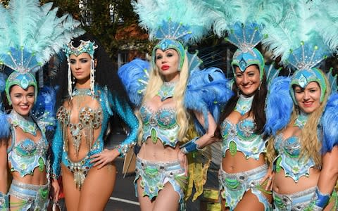 Dancers prepare to take part in the Notting Hill Carnival in west London in August 2018. - Credit: John Stillwell/PA