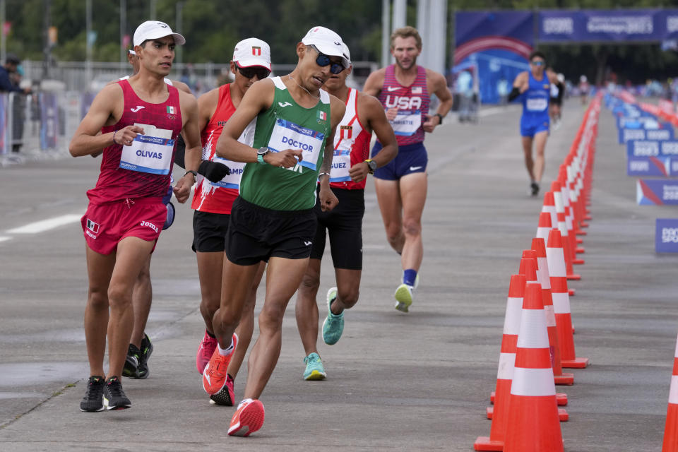 Mexico's Jose Luis Doctor and Mexico's Andres Olivas compete in the men's 20km race walk final at the Pan American Games in Santiago, Chile, Sunday, Oct. 29, 2023. (AP Photo/Moises Castillo)