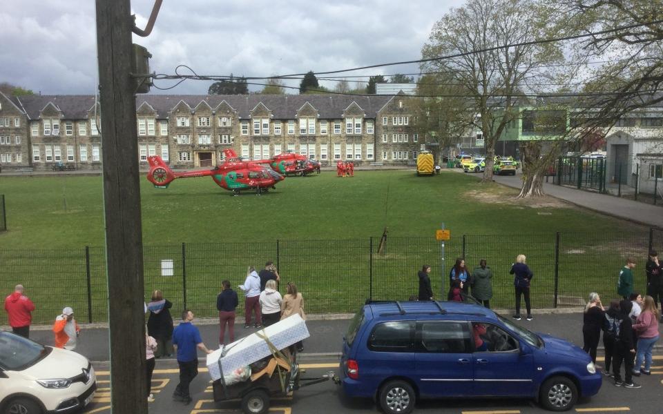 Helicopters in a field next to a school in Wales.