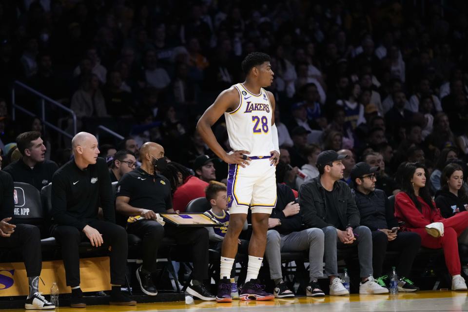 Los Angeles Lakers' Rui Hachimura (28) watches action from the bench during the first half of an NBA basketball game against the Golden State Warriors, Sunday, March 5, 2023, in Los Angeles. (AP Photo/Jae C. Hong)