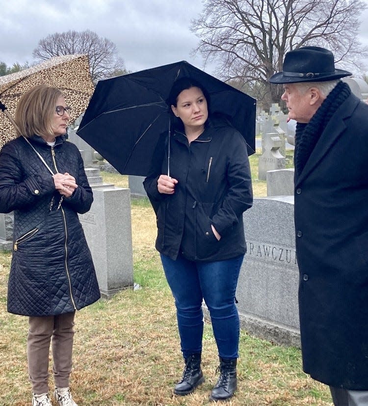 Bucks County Coroner Meredith Bucks (left), Deputy Coroner Kristina Johnson (center) speak with Michael Nasevich. The three worked together to bury the cremated remains of Bucks County's longest unclaimed decedent on March 25, 2023.