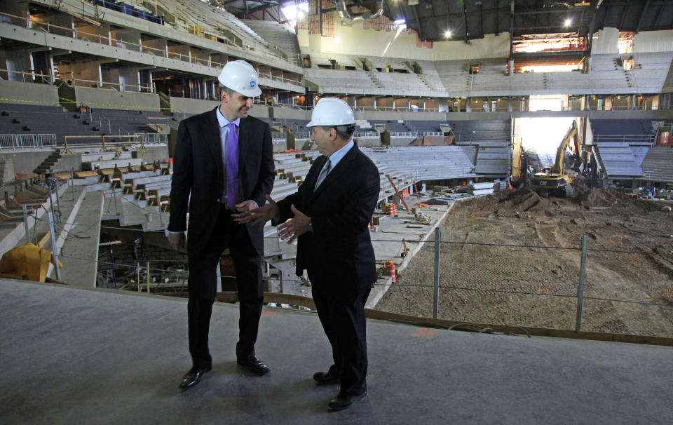 Mikhail Prokhorov, left, Russian billionaire and owner of the New Jersey Nets basketball team, and Bruce Ratner, developer of the Barclays Center arena, speak during a news conference on Tuesday, April 10, 2012 at the arena's construction site in the Brooklyn borough of New York. (AP Photo/Bebeto Matthews)