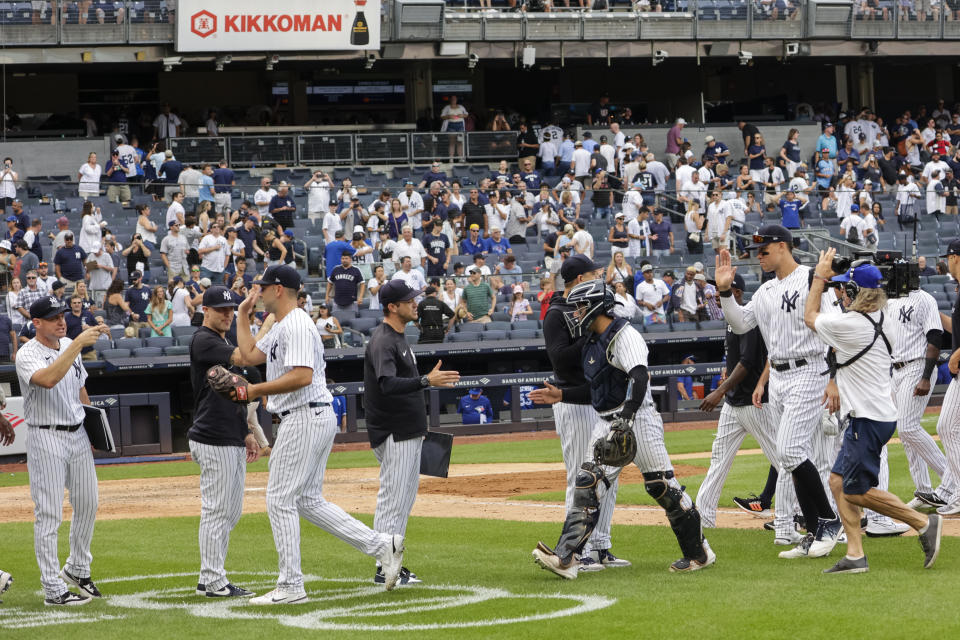 New York Yankees players celebrate after their win in a baseball game against the Toronto Blue Jays, Sunday, Aug. 21, 2022, in New York. (AP Photo/Corey Sipkin)