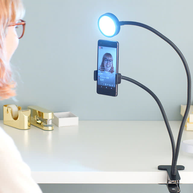 Woman uses Live Streaming Selfie Light to record a video on her phone