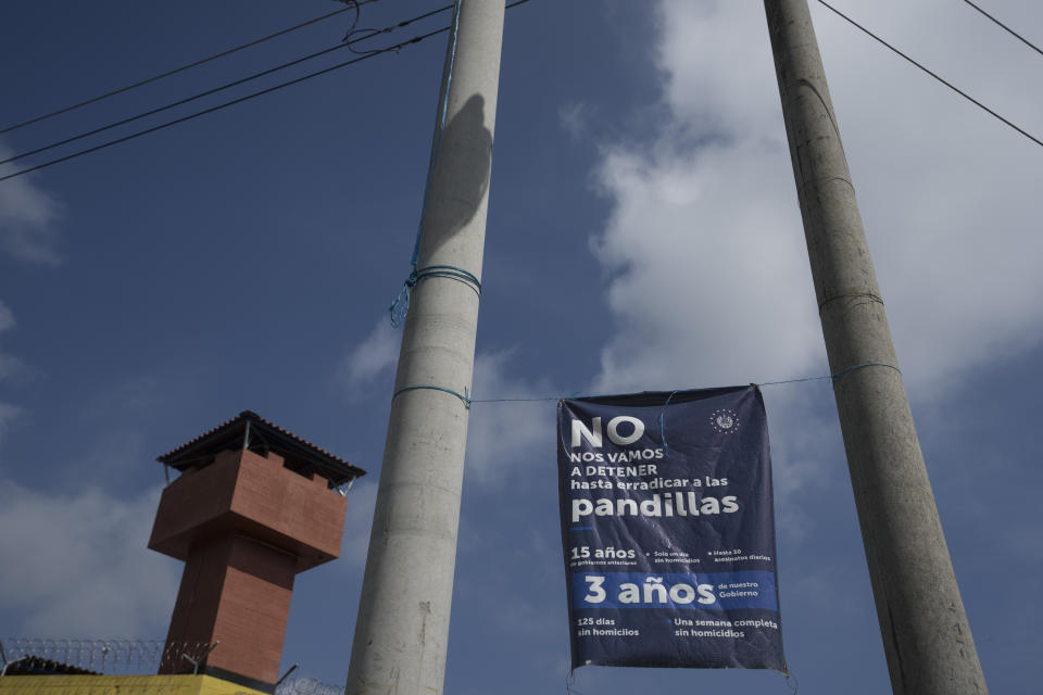 A banner with a message that reads in Spanish: “We will not stop until the gangs are eradicated,” hangs outside the Mariona prison, a main penitentiary for men, on the outskirts of San Salvador, El Salvador, Wednesday, Oct. 12, 2022. (AP Photo/Moises Castillo)