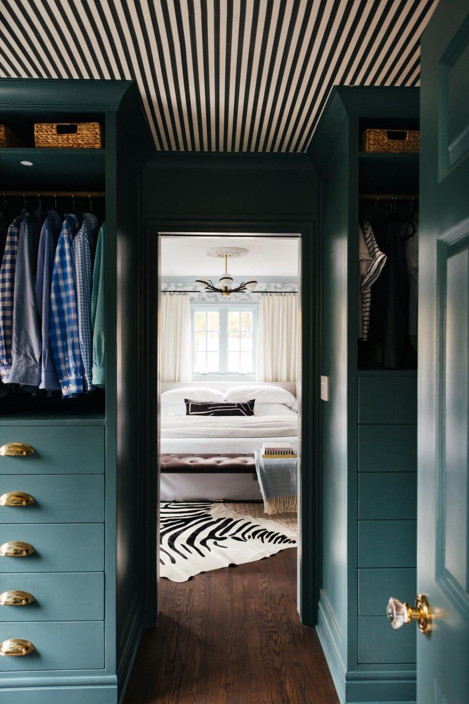 A view from a walk-in closet to a bedroom