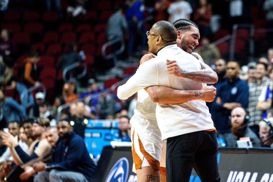 Texas interim head coach Rodney Terry embraces senior forward Timmy Allen after the Longhorns' 71-66 win over Penn State to clinch a Sweet 16 appearance. “Give RT credit,” Allen said. It's the Longhorns' first Sweet 16 trip in 15 years.