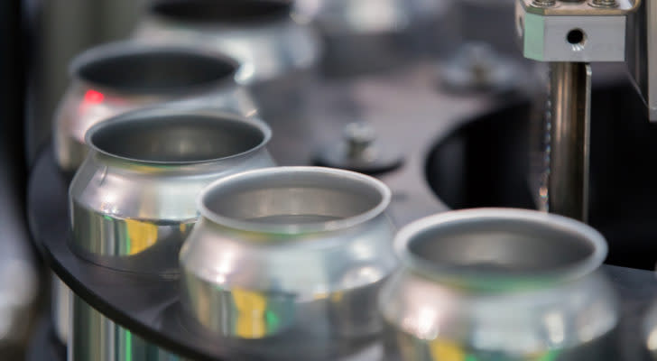 close-up of aluminum cans in assembly line