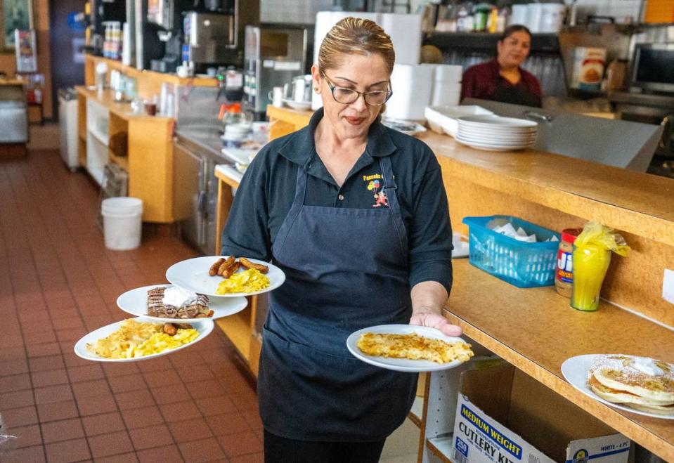 Erica Bermudez, a Pancake Circus server, takes food to customers earlier this month.