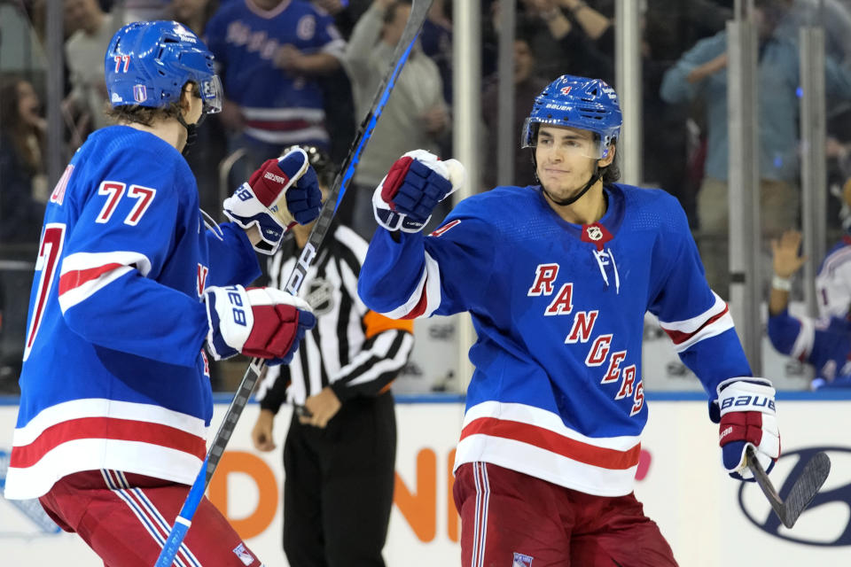 New York Rangers defenseman Braden Schneider (4) celebrates scoring a goal against the New Jersey Devils with defenseman Niko Mikkola (77) during the third period of an NHL hockey game, Saturday, April 29, 2023, at Madison Square Garden in New York. The Rangers won 5-2. (AP Photo/Mary Altaffer)