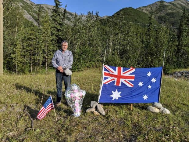 Ed Grennan next to the roadside memorial he created for murdered couple, Lucas Fowler and Chynna Deese. 