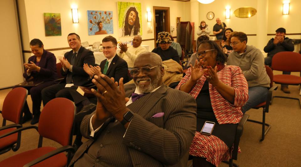 Audience members applaud as Apostle Edward Campbell portrays Frederick Douglass during the Brockton Area Branch NAACP's homage to influential Black leaders at the library on Saturday, Feb. 4, 2023.