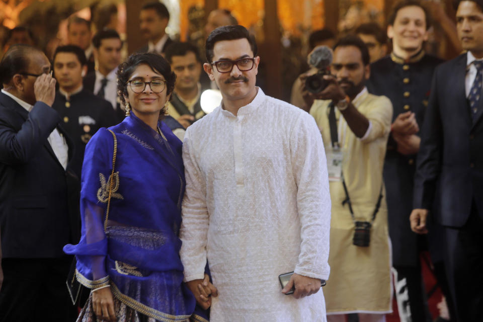 Bollywood actor Aamir Khan and his wife Kiran Rao arrive to attend the wedding of Isha Ambani, the daughter of Reliance Industries Chairman Mukesh Ambani, and Anand Piramal in Mumbai, India, Wednesday, Dec. 12, 2018. In a season of big Indian weddings, the Wednesday marriage of the scions of two billionaire families might be the biggest of them all. Isha is the Ivy League-educated daughter of industrialist Mukesh Ambani, thought to be India's richest man. The groom is the son of industrialist Ajay Piramal, thought to be worth $10 billion. (AP Photo/Rajanish Kakade)