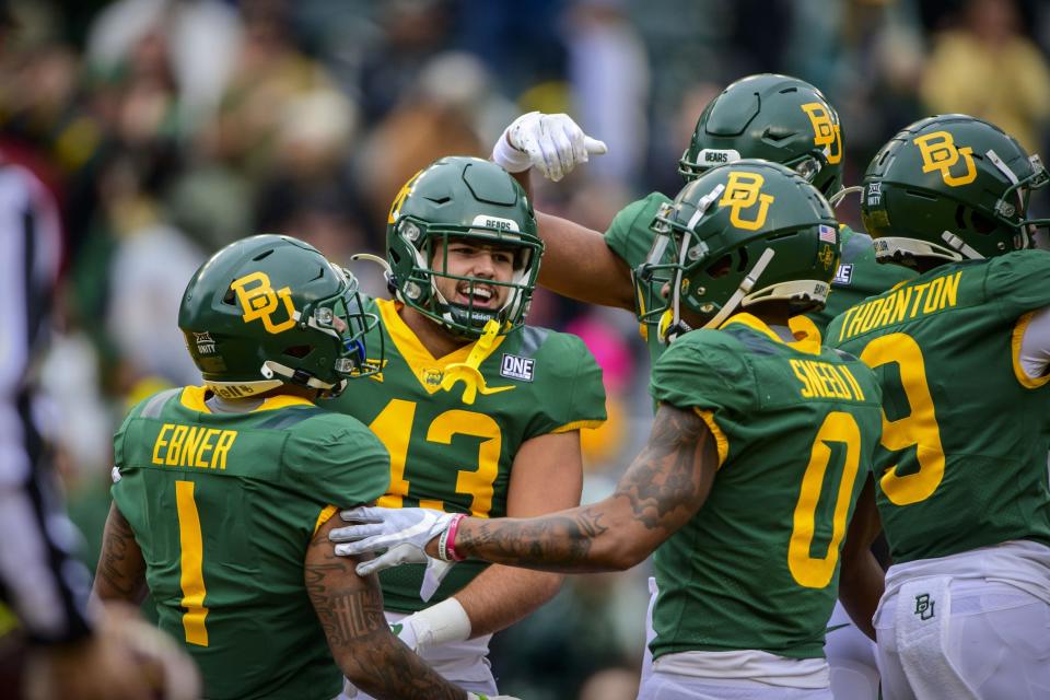 Nov 27, 2021; Waco, Texas, USA; Baylor Bears running back Trestan Ebner (1) tight end Gavin Yates (43) and wide receiver R.J. Sneed (0) and wide receiver Tyquan Thornton (9) celebrate a touchdown by Ebner against the Texas Tech Red Raiders during the first half at McLane Stadium. Mandatory Credit: Jerome Miron-USA TODAY Sports