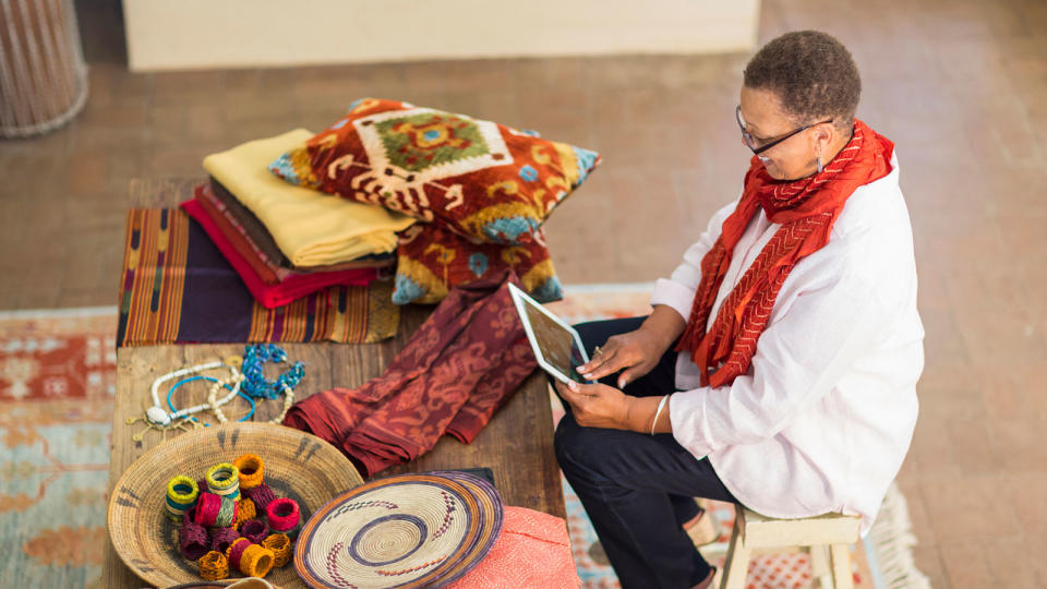 mature woman with crafts and digital tablet
