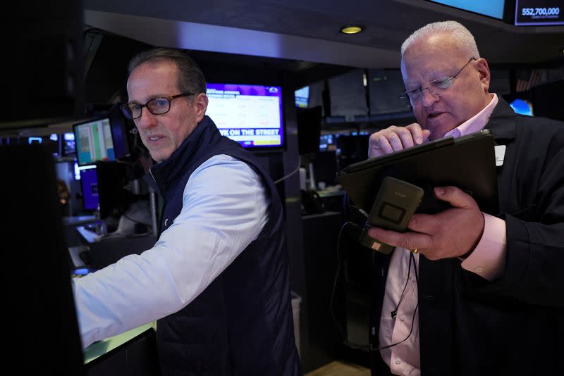 Traders work on the floor of the NYSE in New York