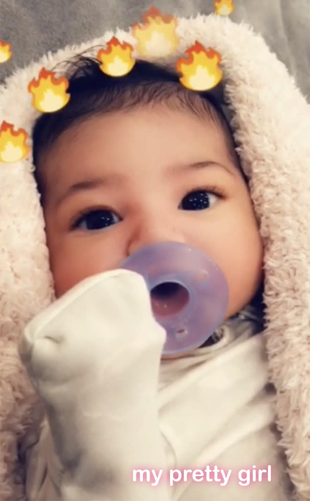 <p>A week earlier, Kylie taught the tot about filters — which is sort of an essential lesson if you are born into the KarJenner family. The March 3 Snapchat video featured the big-eyed beauty sucking on a purple pacifier, with the social network’s fire filter. “My pretty girl,” Kylie wrote. (Photo: Kylie Jenner via Snapchat) </p>