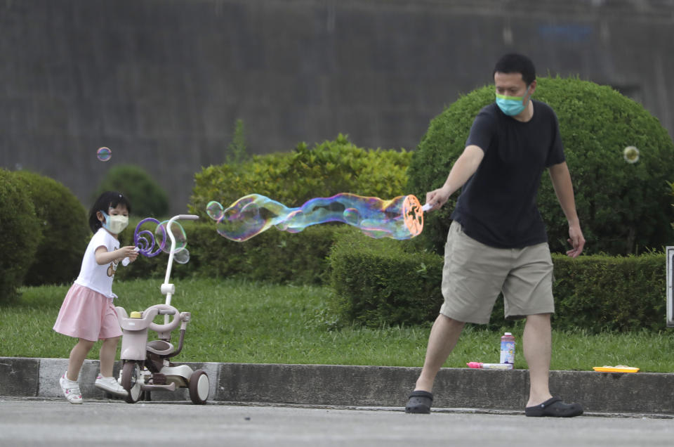 People wear face masks to protect against the spread of the coronavirus in Taipei, Taiwan, Wednesday, April 27, 2022. (AP Photo/Chiang Ying-ying)