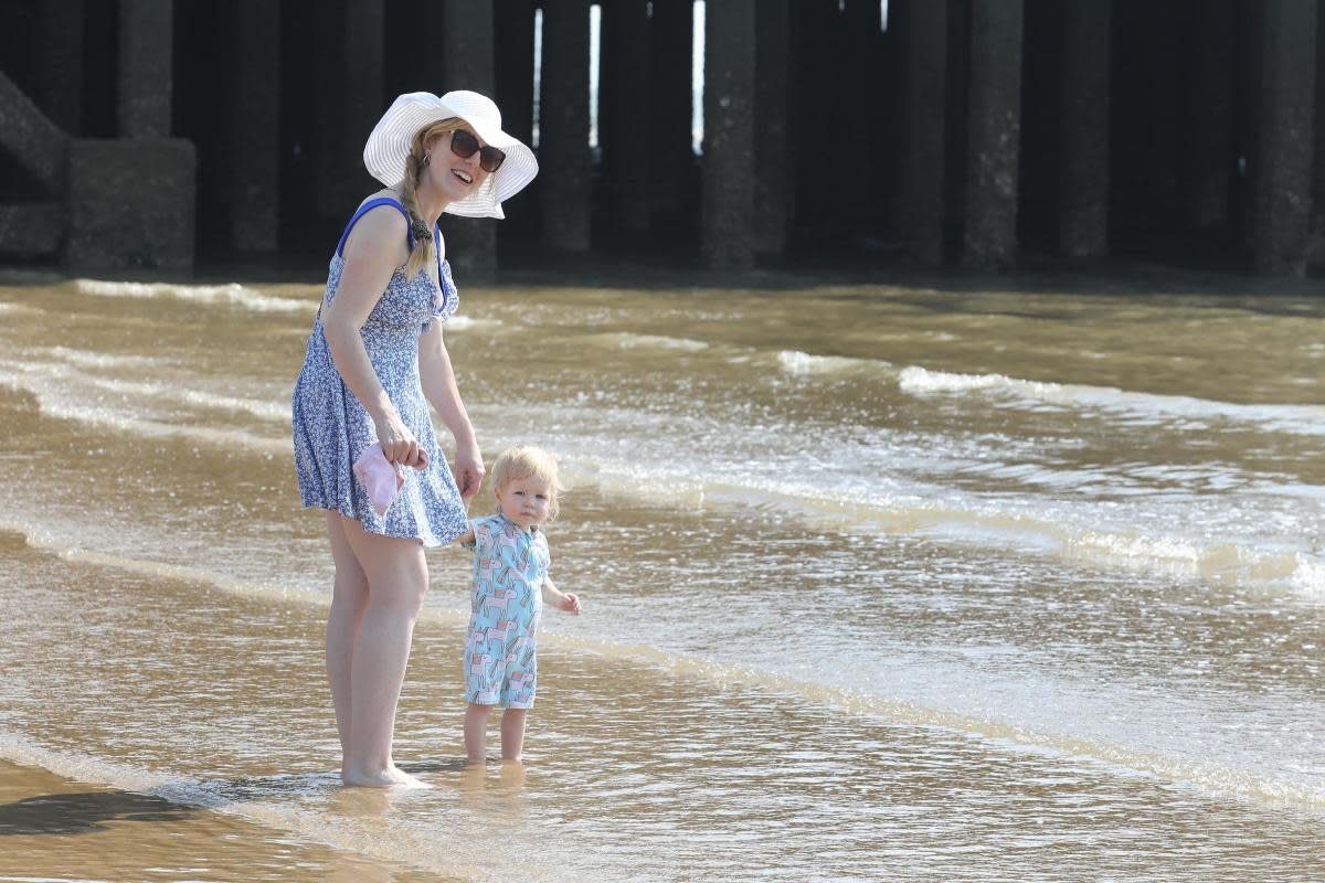 Smiles - Gemma Gayfer with daughter Lottie-Ann, 16 months, enjoying the sea and sun in Clacton <i>(Image: Steve Brading)</i>