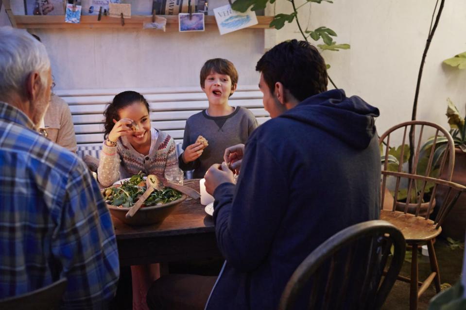 multigenerational family eating a meal at the table