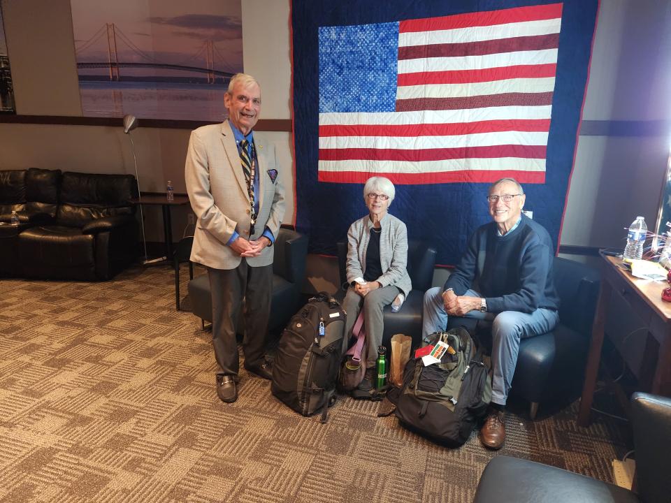 John McCandless, left, co-founder of the Michigan Freedom Center at Detroit Metro Airport,  visits  with  Army veteran David MacIntosh and his wife, Lorah, both of Traverse City, who stopped there Nov. 10 on their way to Hawaii. McCandless was at the center to celebrate its 11th anniversary.