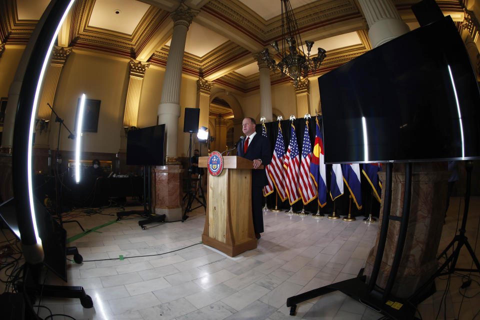 Colorado Governor Jared Polis makes a point during a news conference to update the state's efforts to check the spread of the new coronavirus Monday, May 11, 2020, in Denver. Polis announced that a restaurant in Castle Rock, Colo., that opened Sunday in defiance of state rules barring in-person dining will have its business license suspended temporarily for the action. (AP Photo/David Zalubowski)