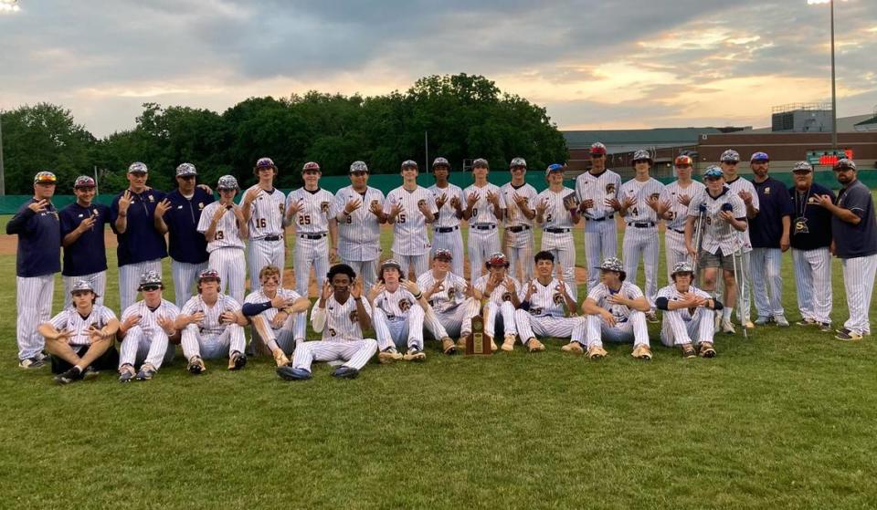 Sayre’s players and coaches held up three fingers to signify the Spartans’ third straight 42nd District Tournament championship Thursday after defeating Scott County 9-4 at Bryan Station High School.