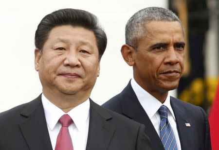 FILE PHOTO - U.S. President Barack Obama (R) stands with Chinese President Xi Jinping during an arrival ceremony at the White House in Washington September 25, 2015. REUTERS/Kevin Lamarque/File Photo