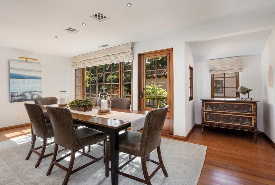 5) Here's the spacious dining room with hardwood flooring, as well as windows that are original to the home.