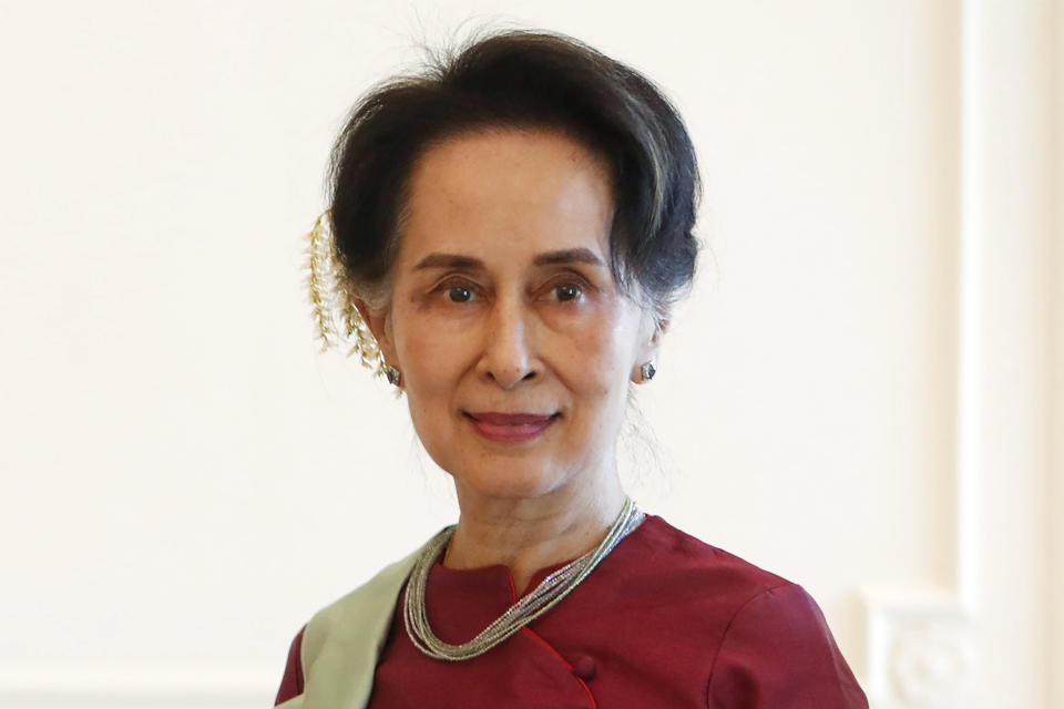 FILE - Myanmar's leader Aung San Suu Kyi receives a final report from Philippine diplomat Rosario Manalo, a member of the Independent Commission of Enquiry for Rakhine State, at the Presidential Palace in Naypyitaw, Myanmar, on Jan. 20, 2020. Myanmar’s military-ruled government and its opponents on Tuesday, July 19, 2022, marked the 75th anniversary of the assassination of independence hero Gen. Aung San, the father of the country’s ousted leader, Aung San Suu Kyi. (AP Photo, File)