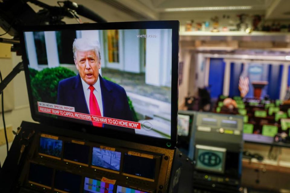 Donald Trump addresses the violence at the US Capitol, as seen on a screen in the White House’s Brady press briefing room, on 6 January.