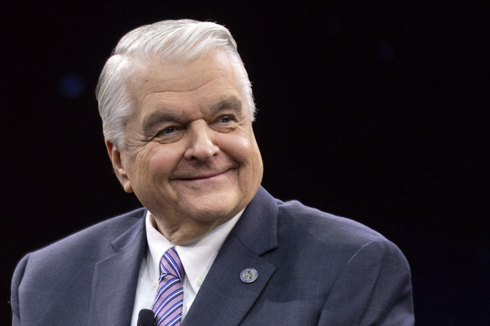 FILE - Gov. Steve Sisolak, D-Nev., reacts to a statement made by Nevada Republican gubernatorial nominee Joe Lombardo in a debate during IndyFest at Worre Studios on Oct. 2, 2022, in Las Vegas. With days ticking down to Election Day on Nov. 8, polls generally show the race close between Sisolak and Lombardo. Sharp and shrill ads funded by the parties, political action committees and campaigns blame each candidate for a range of ills. (AP Photo/Ellen Schmidt, File)