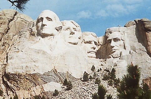 Mount Rushmore, where the sculpted faces of the two Presidents Day presidents -- George Washington and Abraham Lincoln -- flank those of Thomas Jefferson and Theodore Roosevelt.