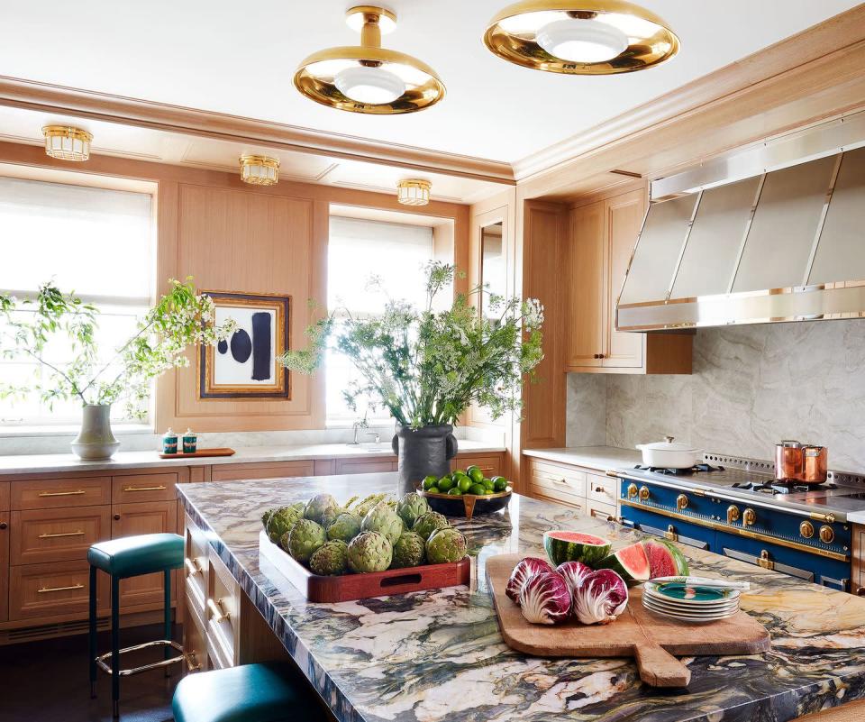<p>A vivid blue La Cornue range was the jumping off point for Summer Thornton’s design of a <a href="https://www.elledecor.com/design-decorate/house-interiors/a37577412/summer-thornton-gold-coast-chicago-prewar/" rel="nofollow noopener" target="_blank" data-ylk="slk:Chicago kitchen" class="link ">Chicago kitchen</a>. Cerused oak cabinetry, a counter in heavily patterned marble, and Roman and Williams Guild pendants add to the room’s dazzle.</p>