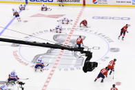A high-angle television camera is viewed as New York Islanders and Washington Capitals players warm up prior to NHL Eastern Conference Stanley Cup playoff hockey action in Toronto, Friday, Aug. 14, 2020. The NHL is providing its playoff teams a few tastes of home in their respective hub cities. Teams are hearing their pre-game warm-up music, goal songs and national anthem performers. Crowd noise is being piped in and new camera angles have been added for a TV audience. (Nathan Denette/The Canadian Press via AP)