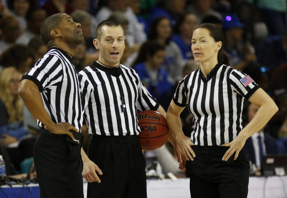 In this Sunday, March 5, 2017, photo, officials Eric Brewton, left, Joe Vaszily, center, and Maj Forsberg stand together during a timeout during the women's basketball game between Duke and Notre Dame at the NCAA college championship basketball game in the Atlantic Coast Conference tournament at the HTC Center in Conway, S.C. Vaszily has worked the last seven Final Fours is looking forward to starting his 21st year this week of Monday, Nov. 23, 2020. He said that a lot of his officiating colleagues are looking forward to the season despite the higher level of anxiety because of the virus. (AP Photo/Mic Smith)