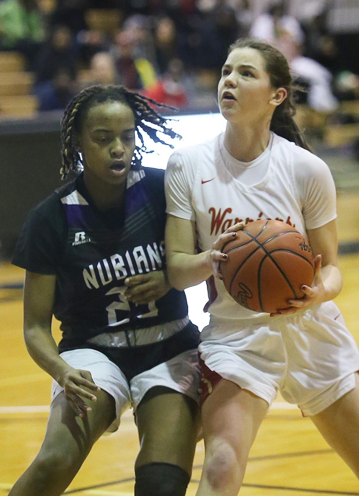 Africentric's Samairah Thompson guards Worthington Christian's Meghan Mayotte as she goes up for a shot in a Division III district final Feb. 25 at Ohio Dominican. Worthington Christian won 43-37.