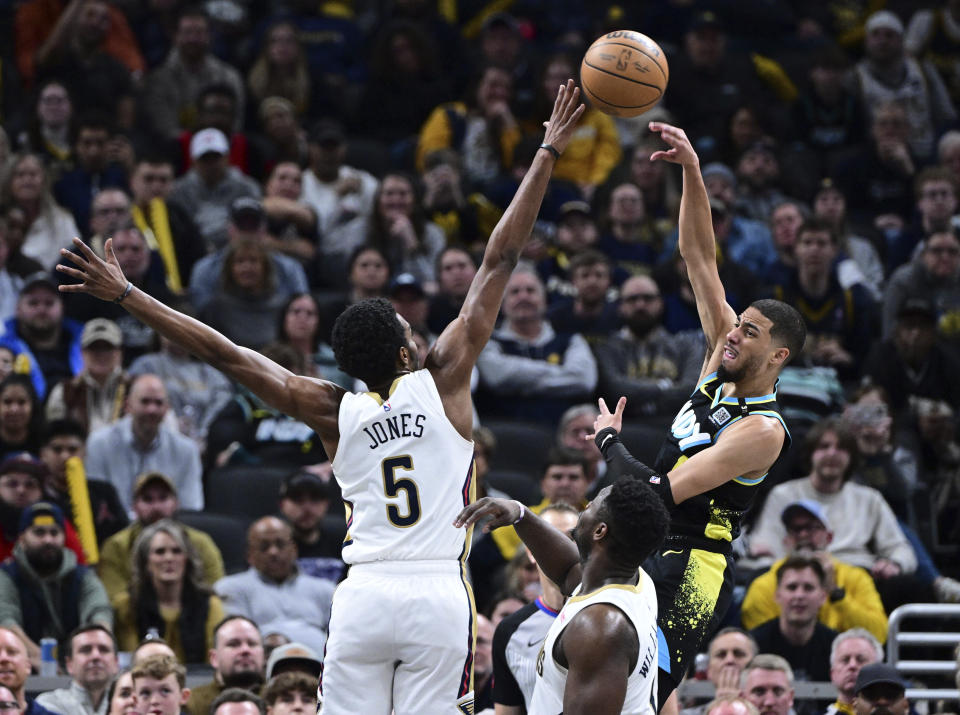 New Orleans Pelicans forward Herbert Jones (5) reaches to block a pass by Indiana Pacers guard Tyrese Haliburton during the second half of an NBA basketball game Wednesday, Feb. 28, 2024, in Indianapolis. (AP Photo/Marc Lebryk)