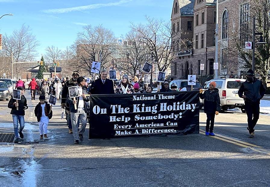 Participants in the annual Martin Luther King Jr. Day march make their way down Sixth Street in Erie Monday afternoon. Nearly 400 people were on hand.