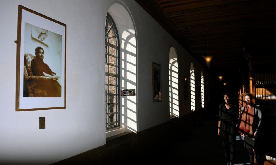 President of the Black Cantabs Research Society Surer Mohamed (left) and University of Cambridge Librarian Jessica Gardner view a portrait of the university’s first black female graduate Gloria Carpenter