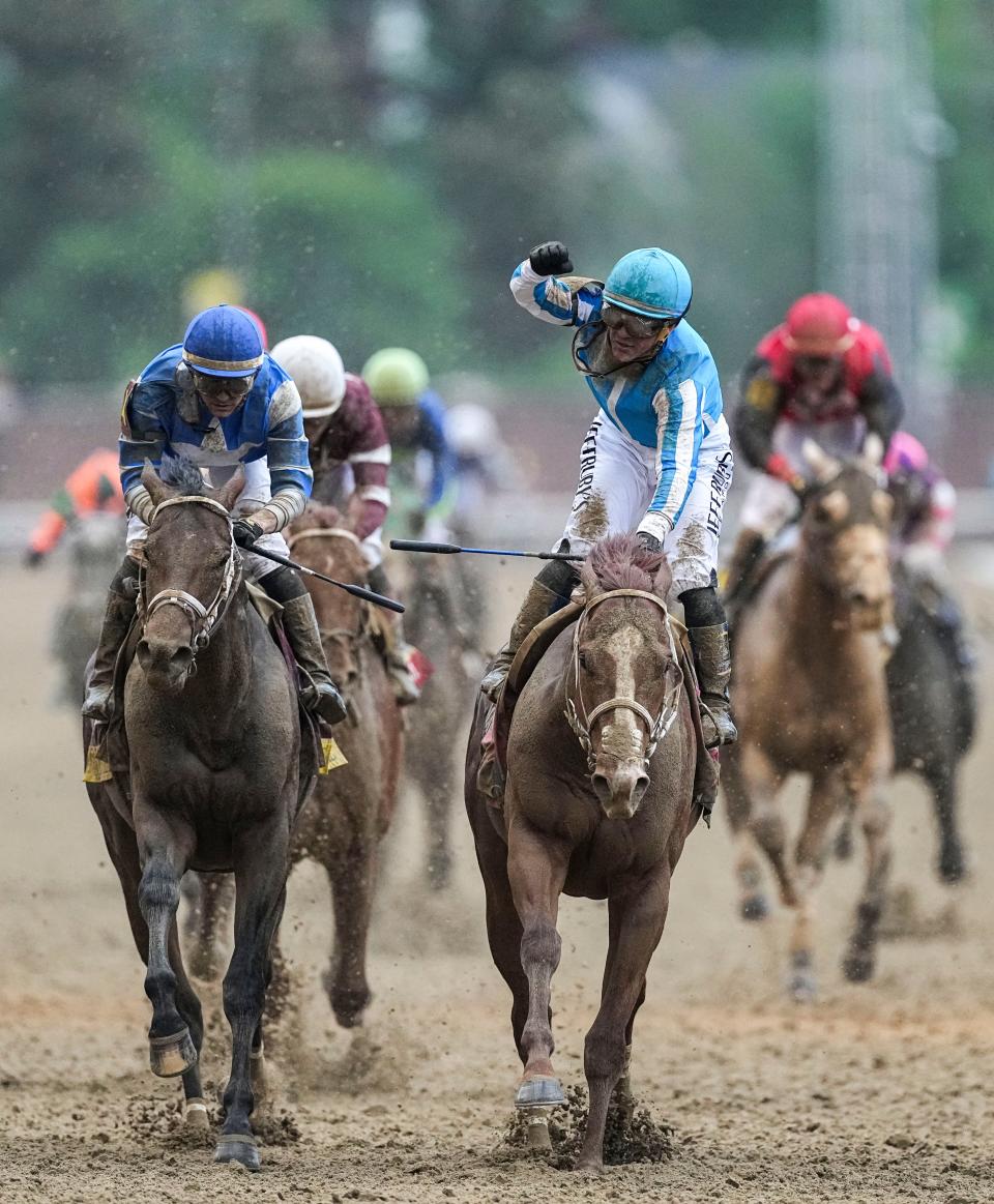 Jockey Javier Castellano raises his fist in celebration after he and Mage won the 149th Kentucky Derby Saturday at Churchill Downs in Louisville, Ky. May, 6, 2023.