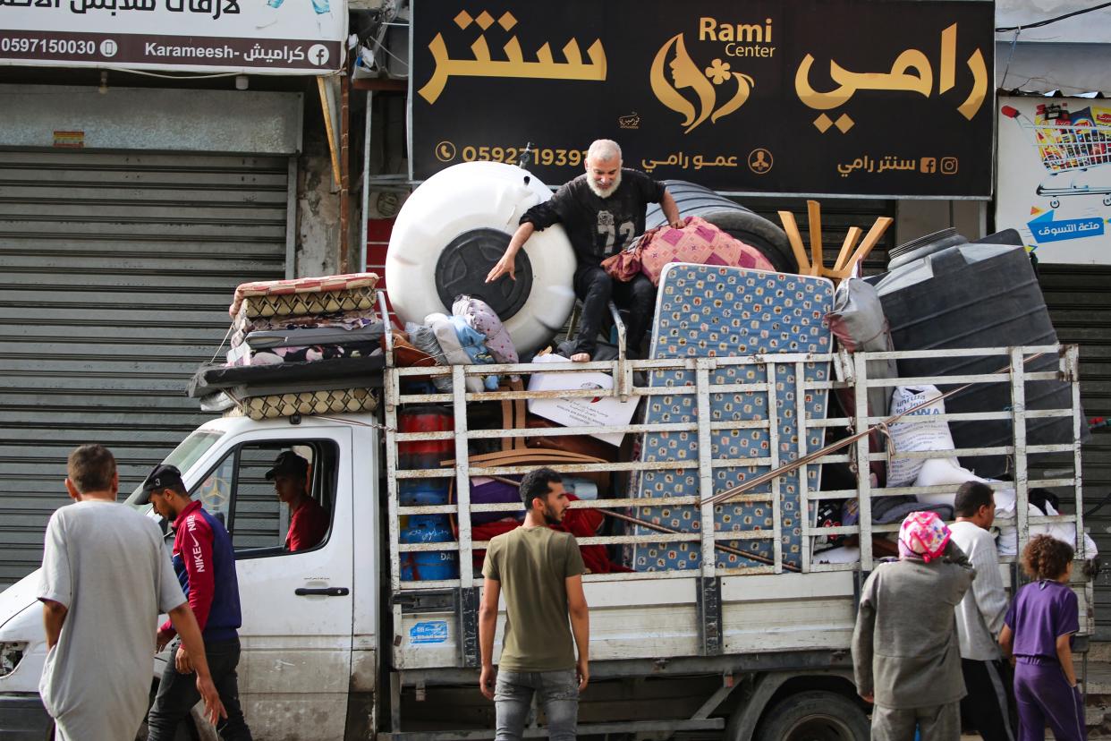 Palestinians load their belongings on the back of a truck this morning as they flee Rafah in the southern Gaza Strip to a safer location (AFP via Getty Images)