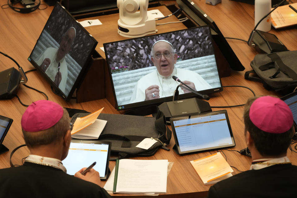Participants in the opening session of the 16th General Assembly of the Synod of Bishops follow Pope Francis on monitors in the Paul VI Hall at The Vatican, Wednesday, Oct. 4, 2023. Pope Francis is convening a global gathering of bishops and laypeople to discuss the future of the Catholic Church, including some hot-button issues that have previously been considered off the table for discussion. Key agenda items include women's role in the church, welcoming LGBTQ+ Catholics, and how bishops exercise authority. For the first time, women and laypeople can vote on specific proposals alongside bishops. (AP Photo/Gregorio Borgia)