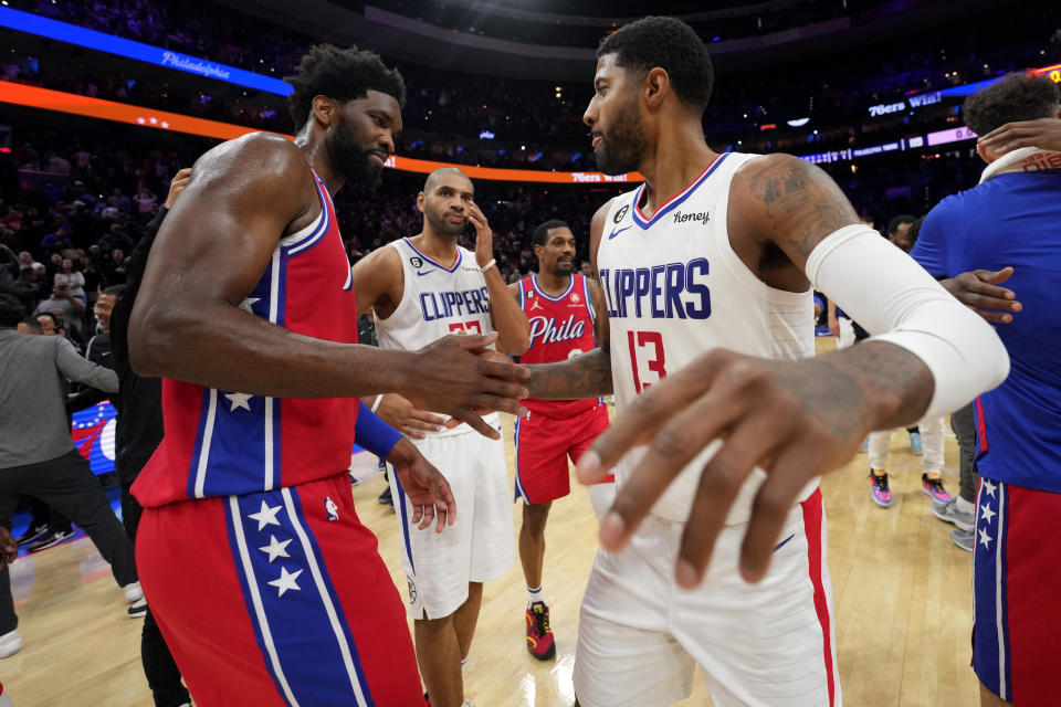 PHILADELPHIA, PA - DECEMBER 23: Joel Embiid #21 of the Philadelphia 76ers high fives Paul George #13 of the LA Clippers after the game on December 23, 2022 at the Wells Fargo Center in Philadelphia, Pennsylvania NOTE TO USER: User expressly acknowledges and agrees that, by downloading and/or using this Photograph, user is consenting to the terms and conditions of the Getty Images License Agreement. Mandatory Copyright Notice: Copyright 2022 NBAE (Photo by Jesse D. Garrabrant/NBAE via Getty Images)