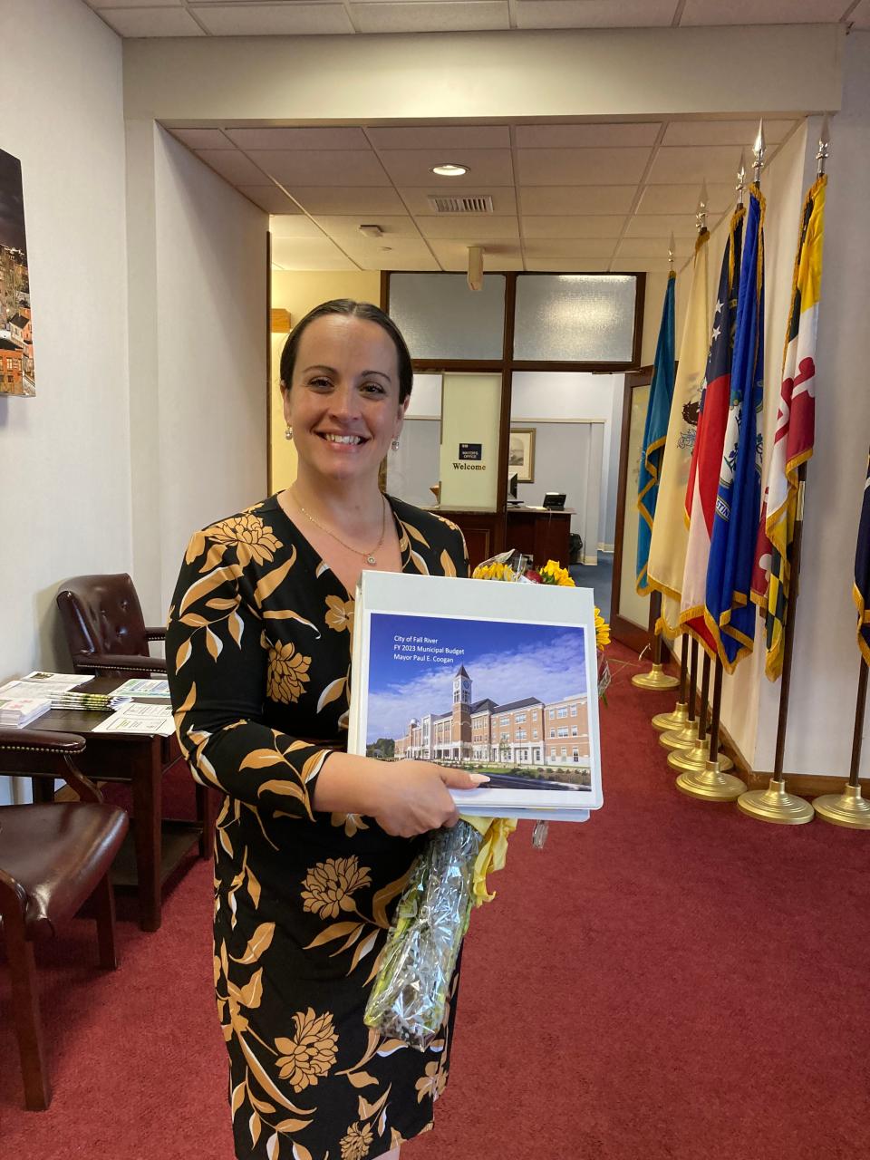City Councilor Laura Washington, holding the proposed 2023 budget book, said she's ready to tackle the challenge.